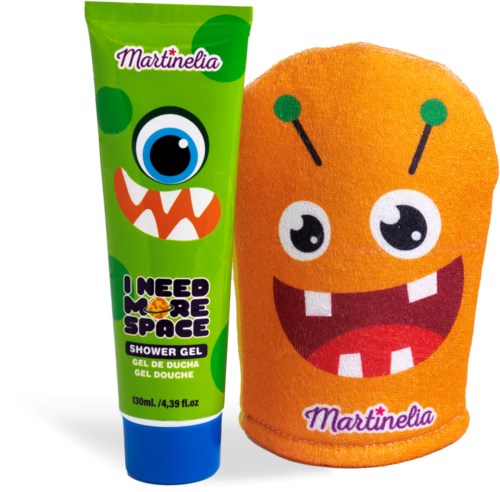 A green shower gel tube labeled 'I Need More Space' and a smiling orange towel with a cartoon face.