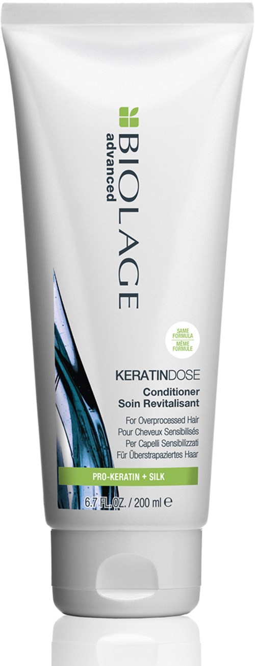A white tube of BioLore Advance Keratin Dose conditioner with green and blue accents, designed for hair care.