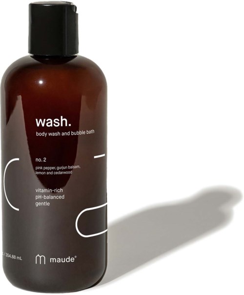 En brun flaske merket 'wash' for kroppsvask og boblebad, med svart lokk og skygge.