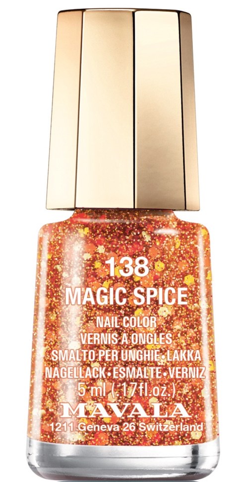 Pieni oranssi kynsilakkapullo kulttipäällä, merkinnällä 'Magic Spice' ja kimalletta sisällä.