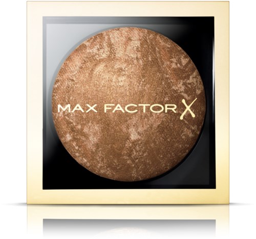 Ett runt, brunt makeup-produkt med orden 'Max Factor X' på, i en kvadratisk låda.