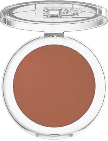 A makeup compact with brown powder inside, clear lid, and white base.
