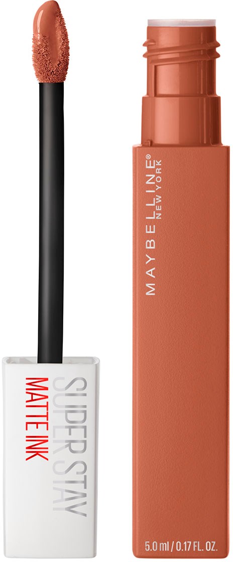 En sminkprodukt med pinne och borste, märkt Maybelline, i persikofärg.