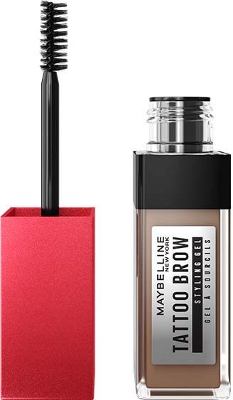 Mascara z różowym uchwytem i szczoteczką. Obok jest butelka Maybelline Tattoo Brow żel.