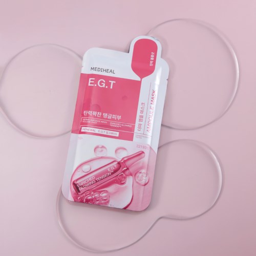 A pink and white package labeled E.G.T for an eye mask, with three transparent eye masks around it.