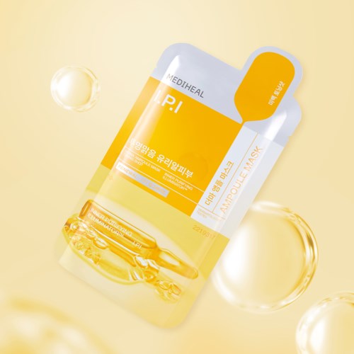 A yellow and white facial mask sachet with Korean text, surrounded by floating glass-like bubbles.