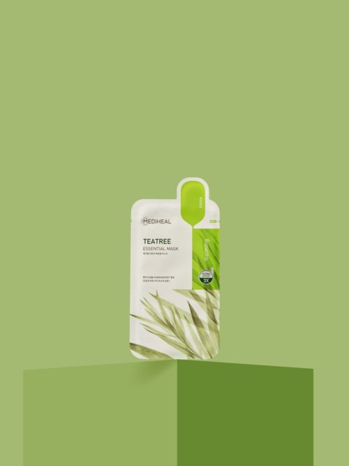 A small green device hangs from a card, promoting teatree essential oil product with leafy design on green background.