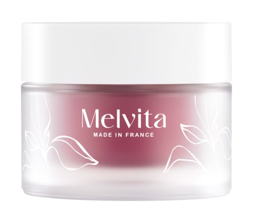 A pink cream jar with white lid and white leaf patterns, labeled Melvita, made in France.