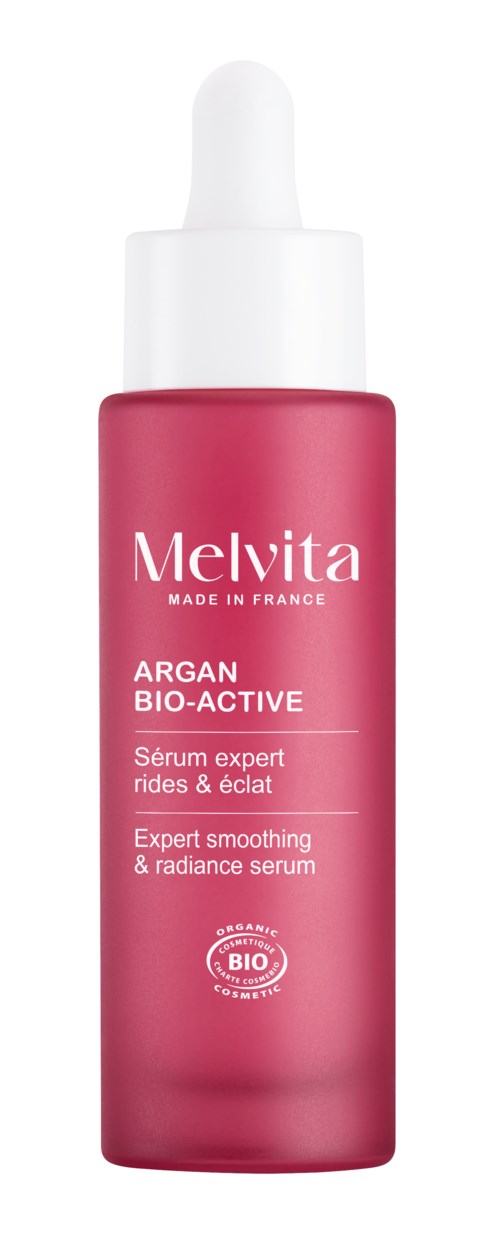 A pink dropper bottle of Melvita Argain Bio-Active serum with text describing it as an expert serum for radiance.
