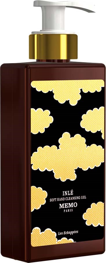 Dark brown bottle with a gold and white cloud design, labeled "INÉ" and "Memmo Paris" skincare product.