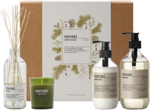 The image shows skincare products including bottles with pumps, a green candle, and a decorative dried plant. A cardboard box is in the background.