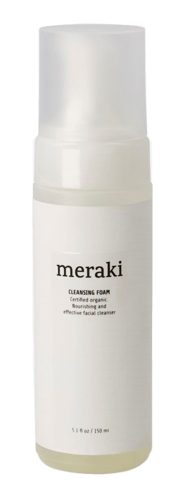 A white bottle of Meraki cleansing foam with a pump, labeled for organic and effective facial cleansing.