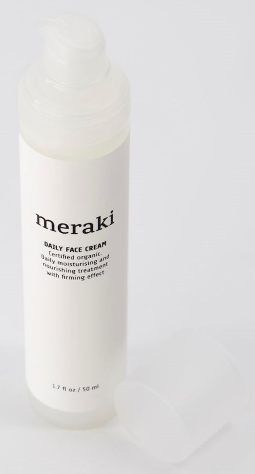 En vit flaska med Meraki Daily Face Cream, 1,7 oz, med enkel svart text och vit topp.