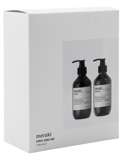 To svarte flasker med Meraki håndpleieprodukter på en hvit eske. Esken viser bilde av flaske. Meraki og produktnavn står på flaskene.