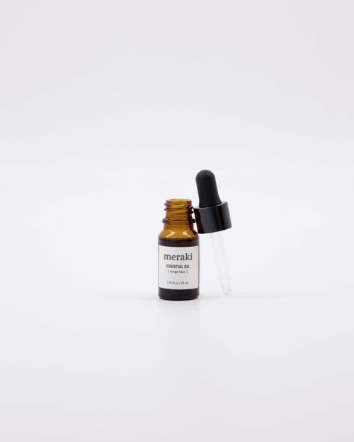 Pieni ruskea pullo mustalla tiputusläpällä, merkinnällä 'meraki' ja 'essential oil'.