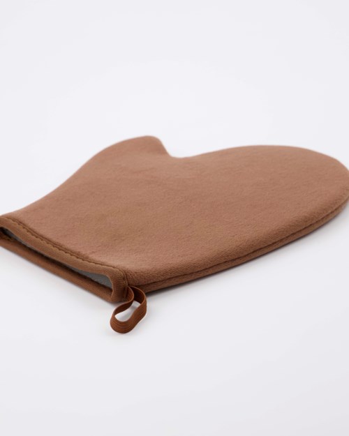 A brown soft pouch with a zipper, lying on a white surface.