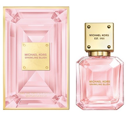 Eine rosafarbene Parfümflasche und Verpackung mit goldenen Akzenten, beschriftet 'MICHAEL KORS SPARKLING BLUSH'.