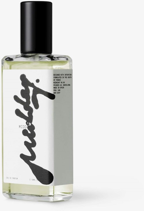 A perfume bottle with a black cap, clear glass, and a white label with large black text.