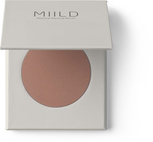 En kompakt blush märkt 'MILD' med naturliga mineralingredienser, i en vit låda med en rosa nyans inuti.