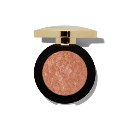A round makeup blush with a black case and a gold lid, containing pinkish blush with gold flakes.