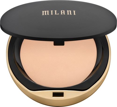 A round compact with a beige powder inside and a black and gold lid labeled 'Milani.'