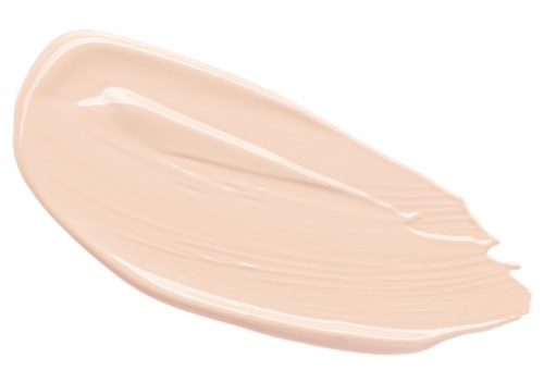 En beige væske spredt ut i en tykk stripe på en hvit overflate.