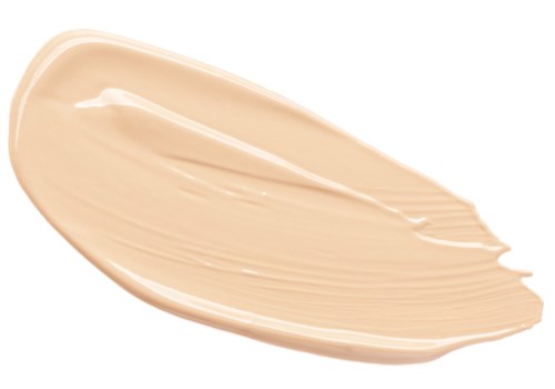Krämig beige lotionstrykning på svart bakgrund.