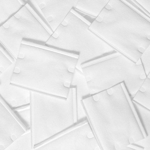 Multiple white blank tags with strings are scattered, overlapping on a surface.
