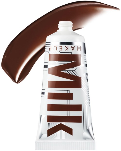 A white tube with brown and black text, and a large brown paint stroke behind it.