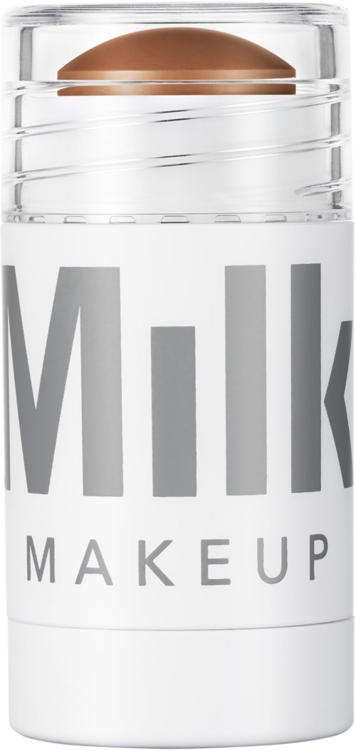 En beholder merket 'Milk Makeup' med en metallisk brun sfærisk gjenstand på toppen.
