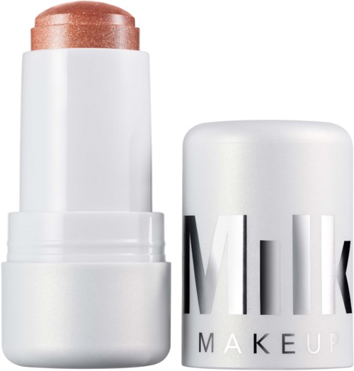 A white stick with a shiny, beige top, labeled 'Milk Make Up' on the cap.