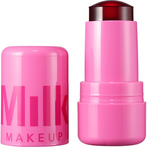 Rosa Lippenstiftbehälter mit Lippenstift darin, neben einem rosa Deckel. Helles und buntes Make-up-Produkt.