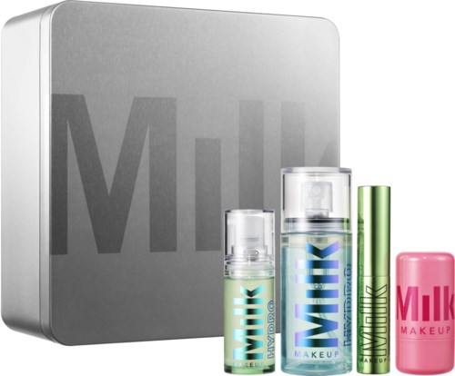 Set Milk Makeup verzorgingsproducten met sprays, stick en bar voor huidverzorging, voor een zilveren Milk Cosmetics doos.