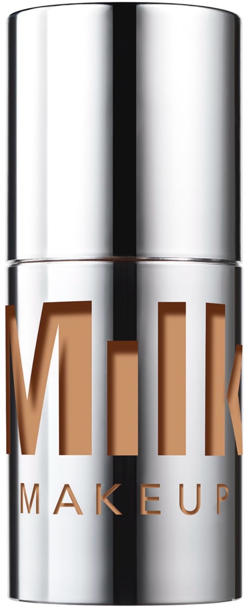 Hopea värinen sylinterimäinen säilytin, jossa lukee "MILK MAKEUP" ruskealla tekstillä.