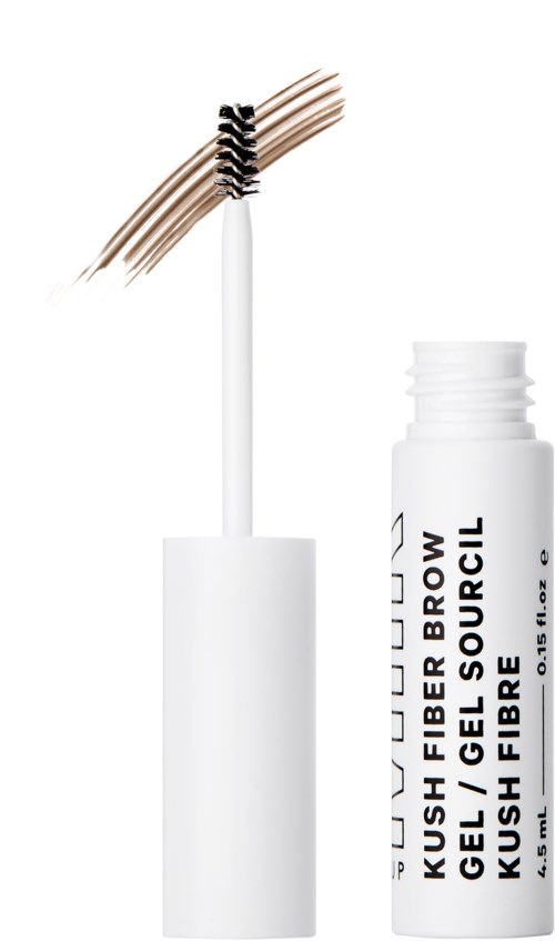 Pieni valkoinen pullo, jossa on musta kansi ja harja, joka näyttää ruskean kulmageelin. Tuoten nimi on 'KUSH FIBER BROW GEL'.