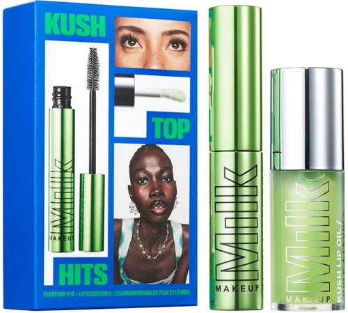 Läppoljepåse och mascara bredvid en färgglad reklam för Kush Top. Reklamen visar två kvinnor med olika ögonlook.
