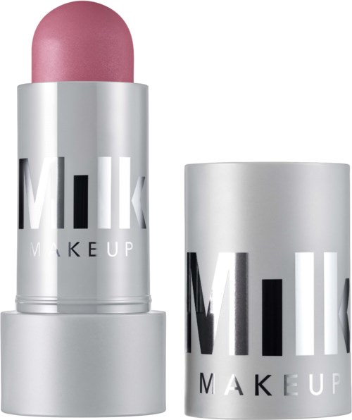 Läppbalsam i rosa nyans med silverförpackning, märkt M.I.L.K MAKEUP, står upprätt bredvid en matchande förvaringsburk.