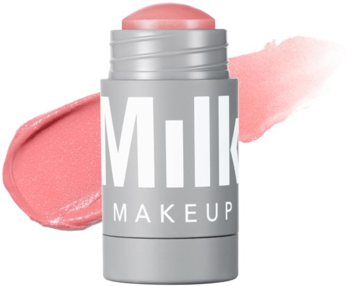 A pink cream stick with a grey and white container and the words 'Milk Makeup'.