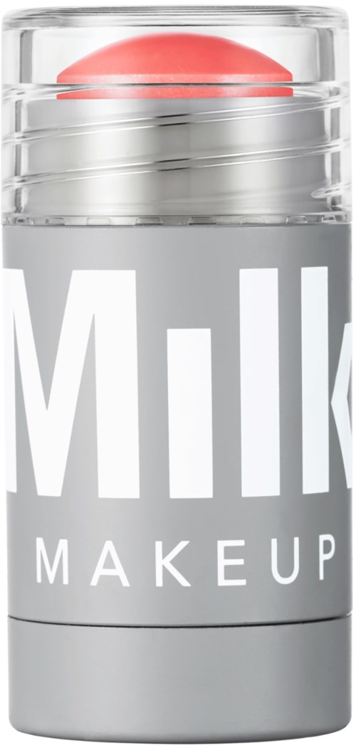 A container with a lid, labeled "Milk Makeup," containing a pinkish-red spherical object inside.