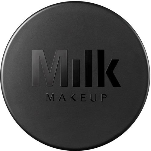 A black, round container with the words "Milk Makeup" engraved on it.