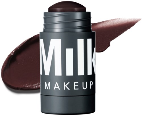A makeup stick labeled 'Milk Makeup' with brown lipstick and swipes of brown makeup.