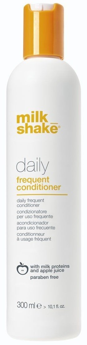 En hvit flaske med oransje kork, merket Milk Shake Daily Conditioner, inneholder melkeproteiner og eplejuice, parabenfri.