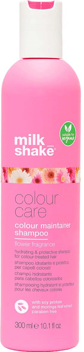 Pinkki pullo Milk Shake värihoitoshampooa, jossa kukkainen tuoksu ja vegaanimerkintä.