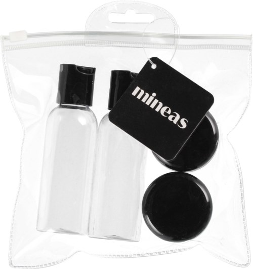 Two small clear bottles with black caps, a black dish, and a label with 'mineas' on a plastic bag.