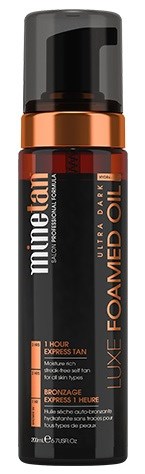 En flaska mörk brunfärgning foam med pump, märkt 'MineTan Luxe Foam Dark', med svarta, orange och silverfärger.