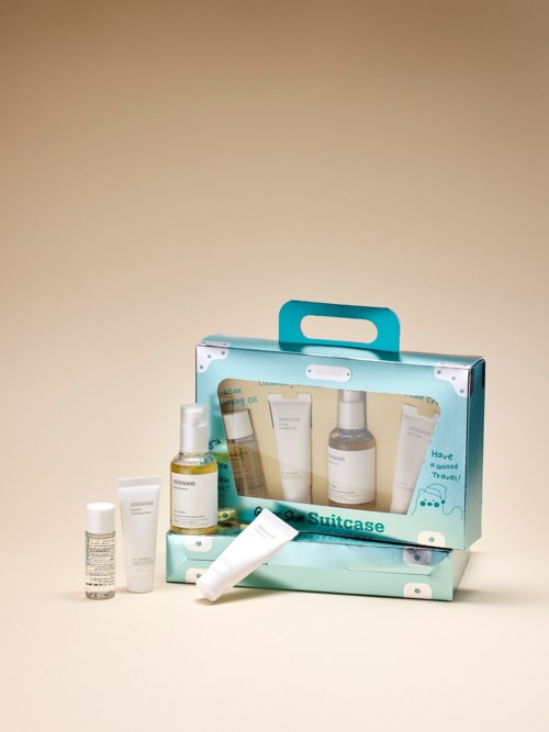 Travel-sized skincare products in a blue case, including bottles, tubes, and containers. Bright and organized.