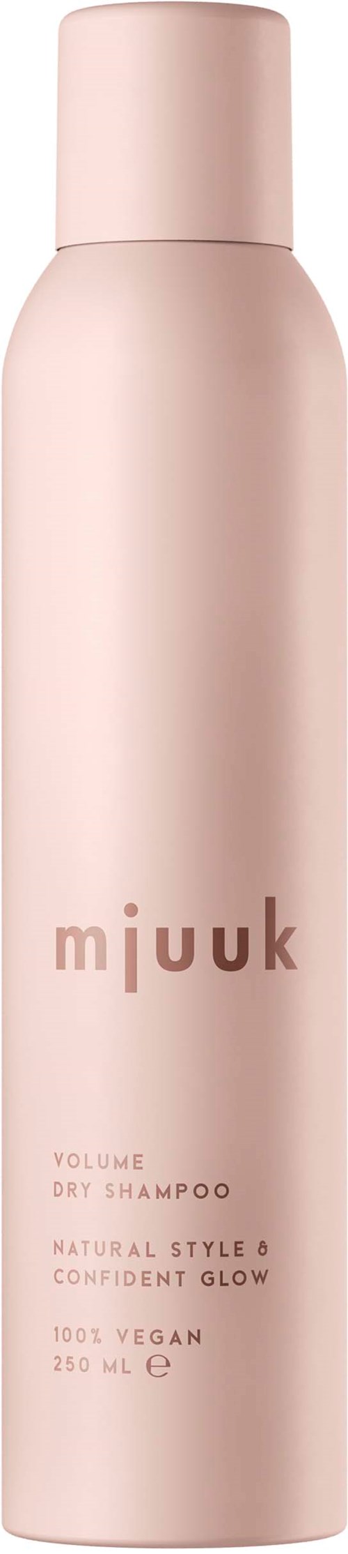 En ljusrosa flaska med Mjuuk torrschampo med text om veganska ingredienser och naturlig stil.