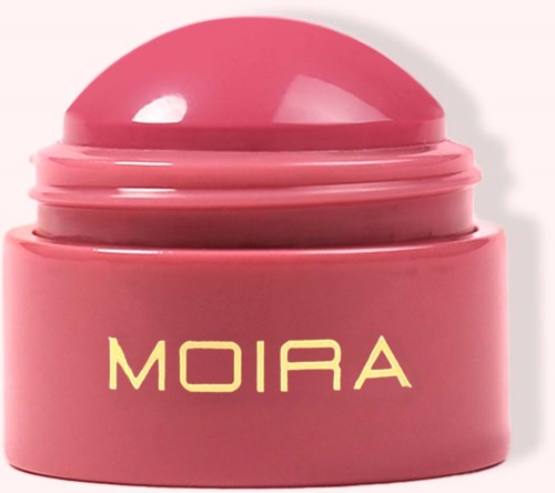 Pink round container with a dome lid, labeled 'MOIRA' in yellow. Likely a cosmetic or skincare product.