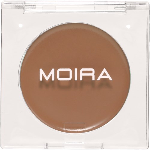 Ett kompakt sminkartikel märkt 'MOIRA' med ljusbrun färg inuti. Det verkar vara ett puder eller rouge.