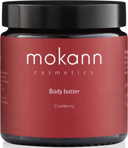 En beholder med Mokann kropsbutter med tranebærduft, sort låg og lyserødt etikette.